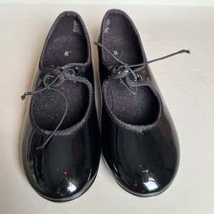 Children’s black American ballet theater, spotlights tap shoes.